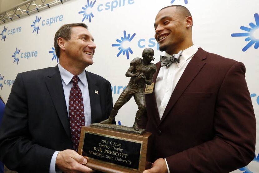 Mississippi State quarterback Dak Prescott and coach Dan Mullen hold the Conerly Trophy in...