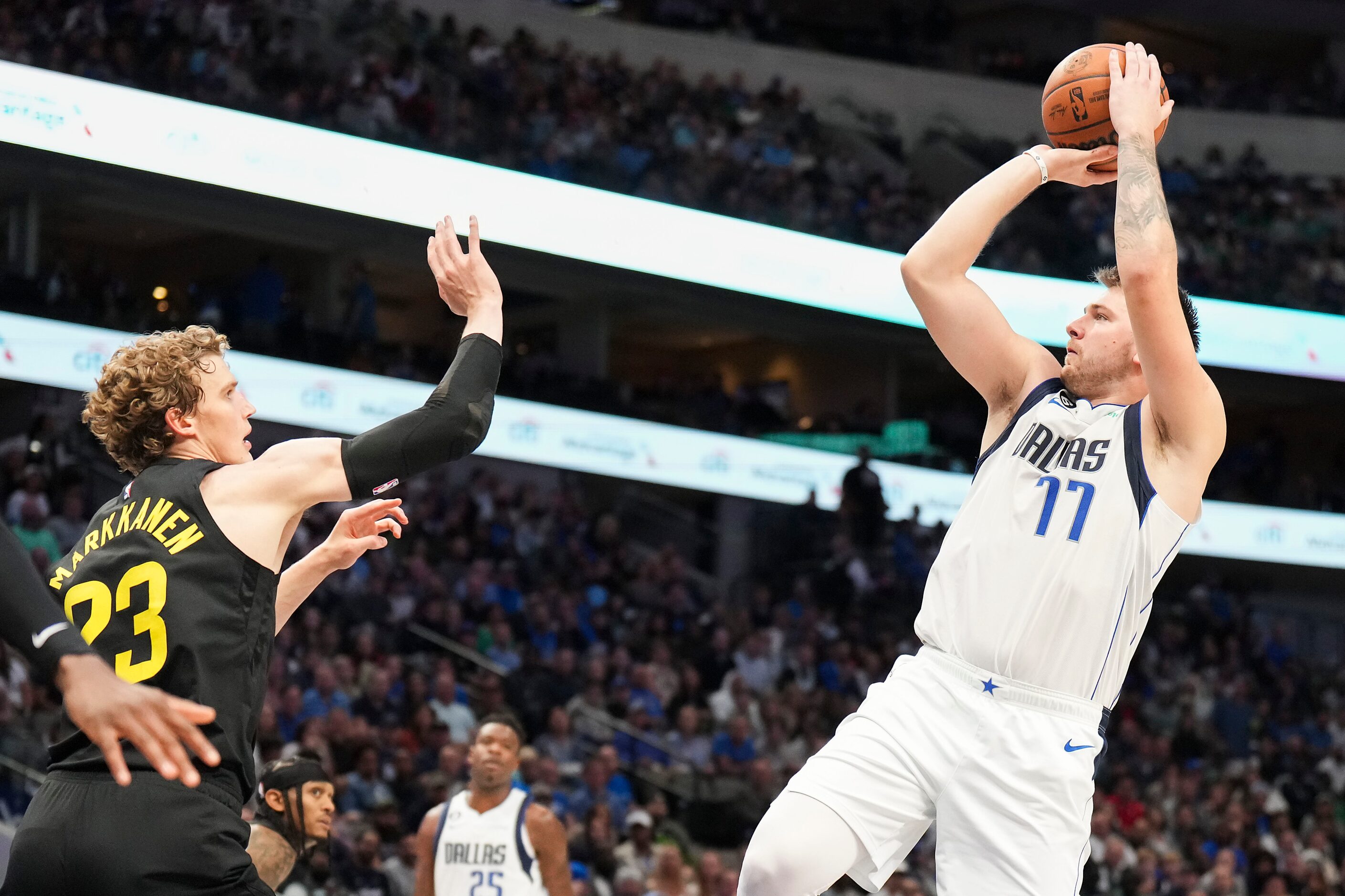 Dallas Mavericks guard Luka Doncic (77) shoots over Utah Jazz forward Lauri Markkanen (23)...