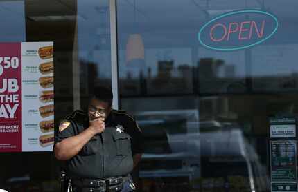 An officer stands outside a Subway in Houston on Thursday. (J. Patric Schneider/Houston...