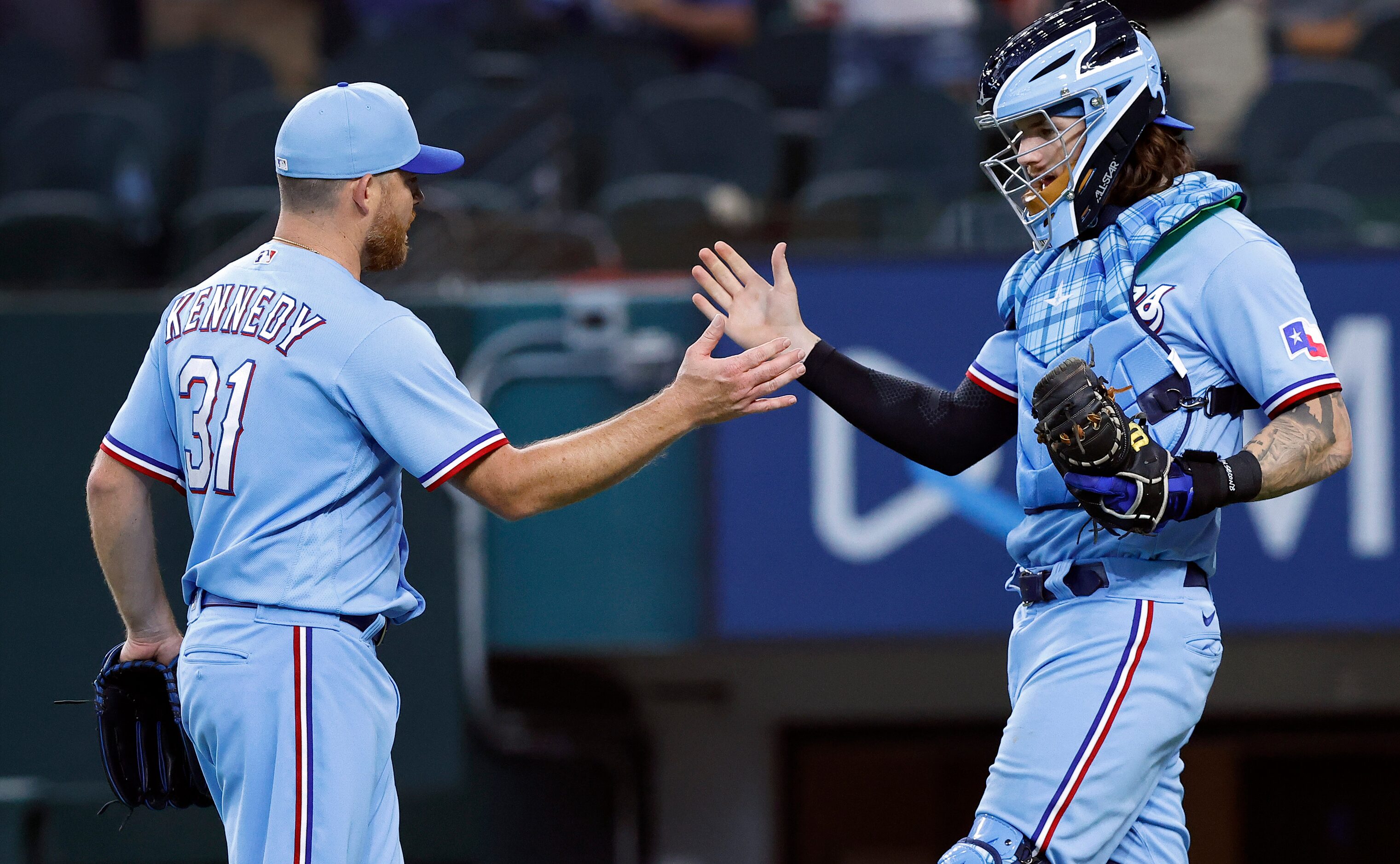 Texas Rangers relief pitcher Ian Kennedy (31) is congratulated by catcher Jonah Heim (28)...