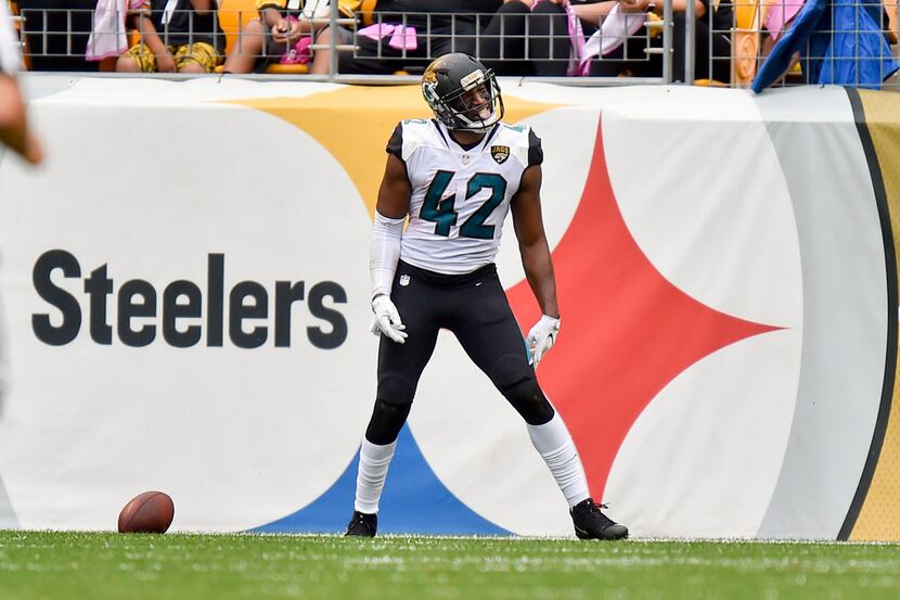 Jacksonville Jaguars strong safety Barry Church (42) celebrates after returning a [ass from...