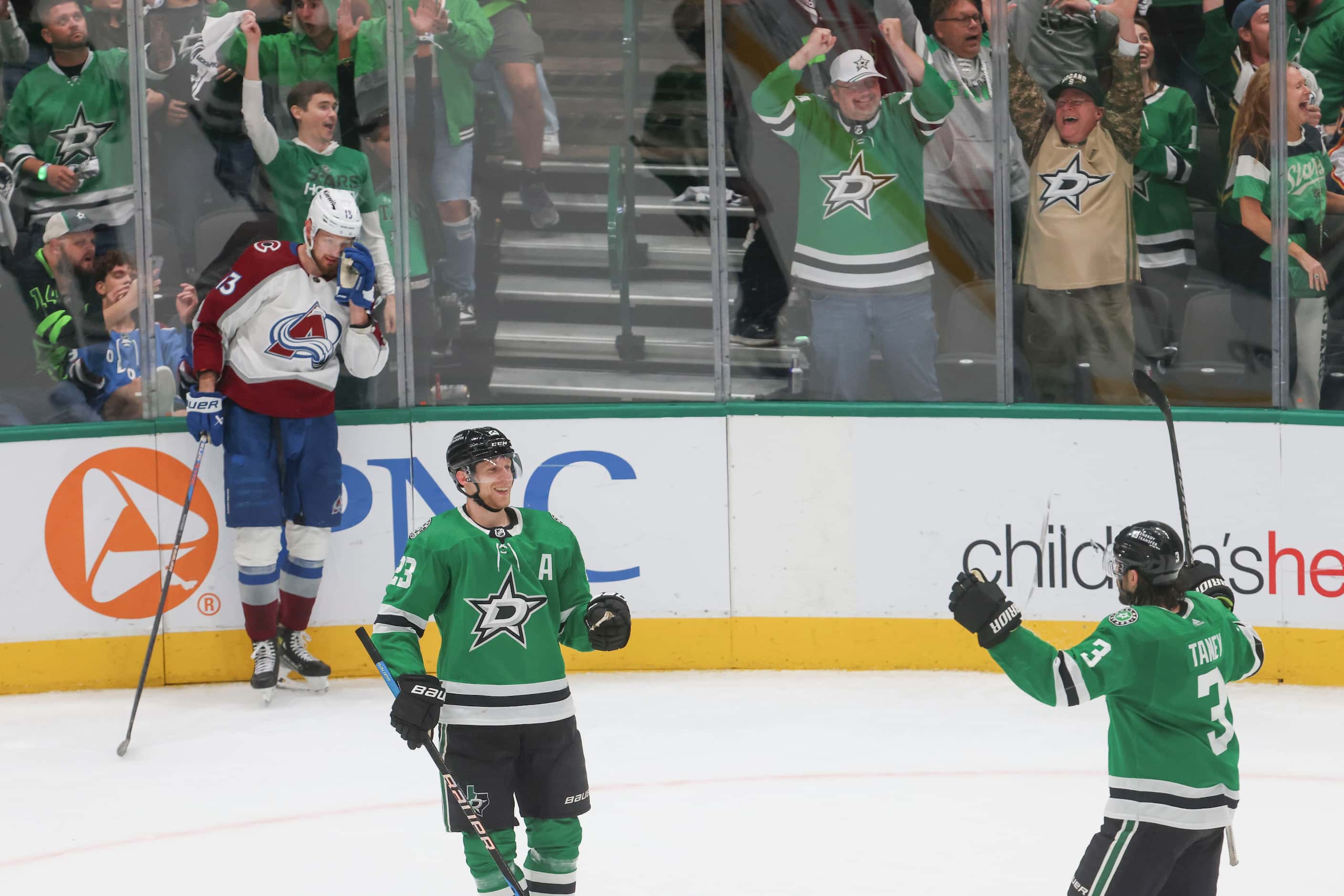 Crowd cheer following the final goal scored by Dallas Stars defenseman Esa Lindell (front...