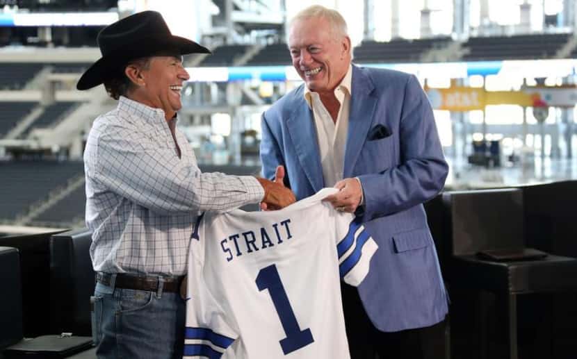 Jerry Jones presents country superstar George Strait with a Cowboys jersey during a press...