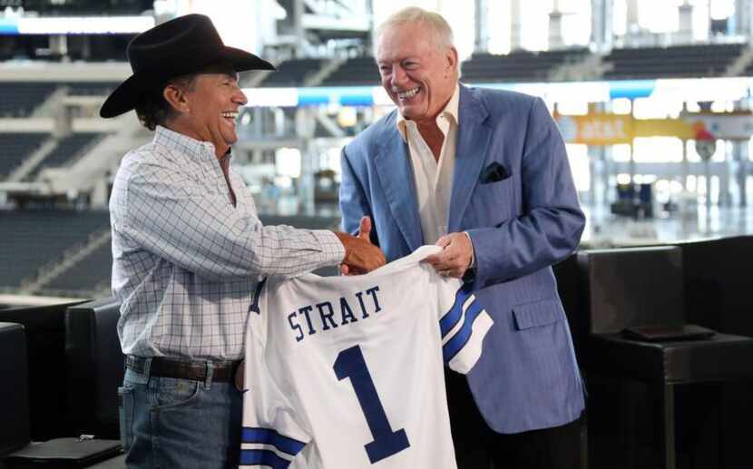 Jerry Jones presents country superstar George Strait with a Cowboys jersey during a press...