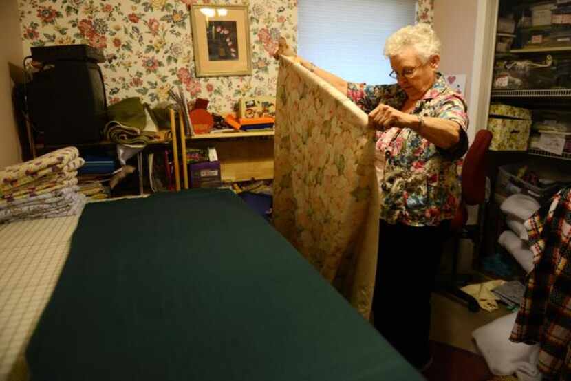 
Devony “Dee” Duhe holds a piece of fabric she will use to make a blanket for ZimKids Orphan...