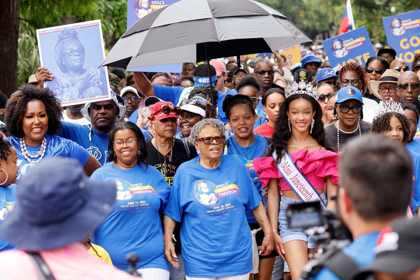 Opal Lee, the Grandmother of Juneteenth, center, walks through Fair Park with her...