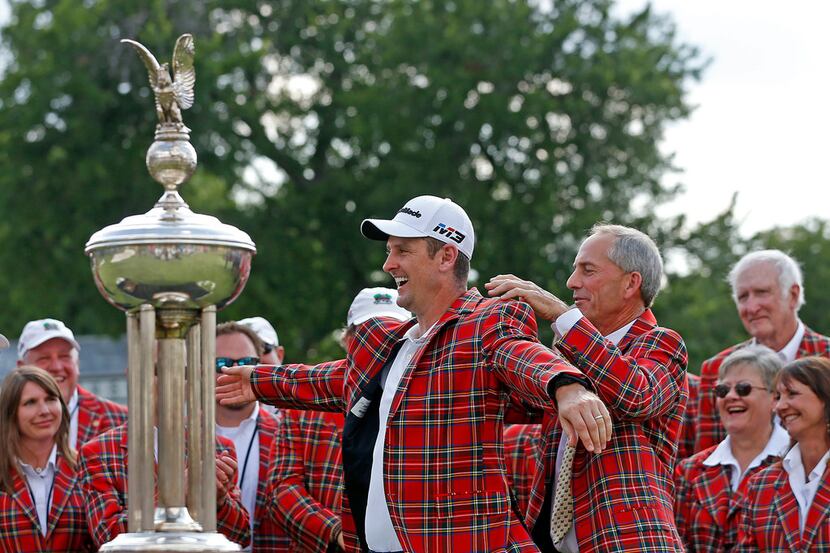 Winner Justin Rose, left, accepts the winners plaid jacket from Colonial golf pro Dow...