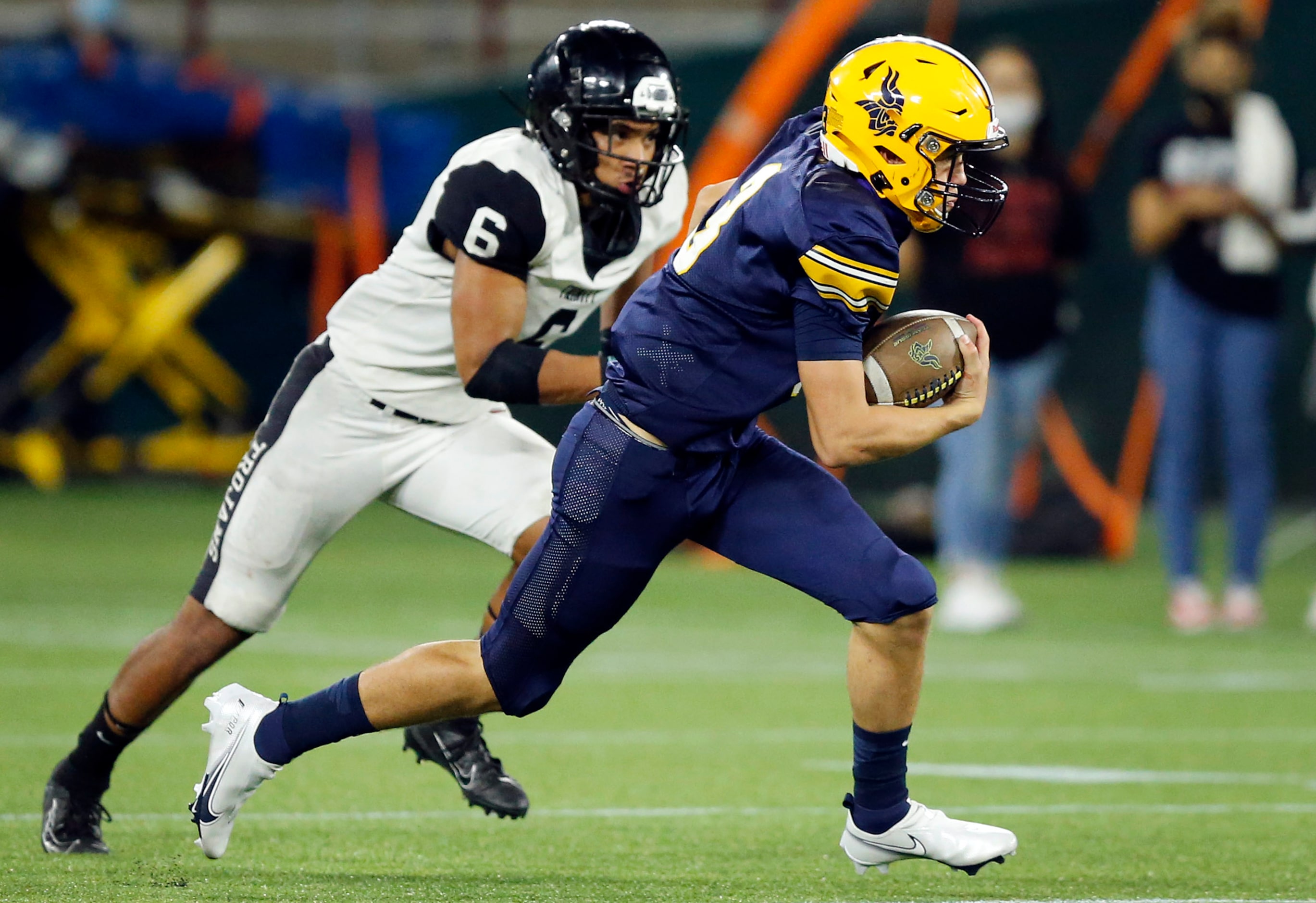 Arlington Lamar quarterback Cade Carlson (3) eludes Euless Trinity's Nai Mose (6) during the...