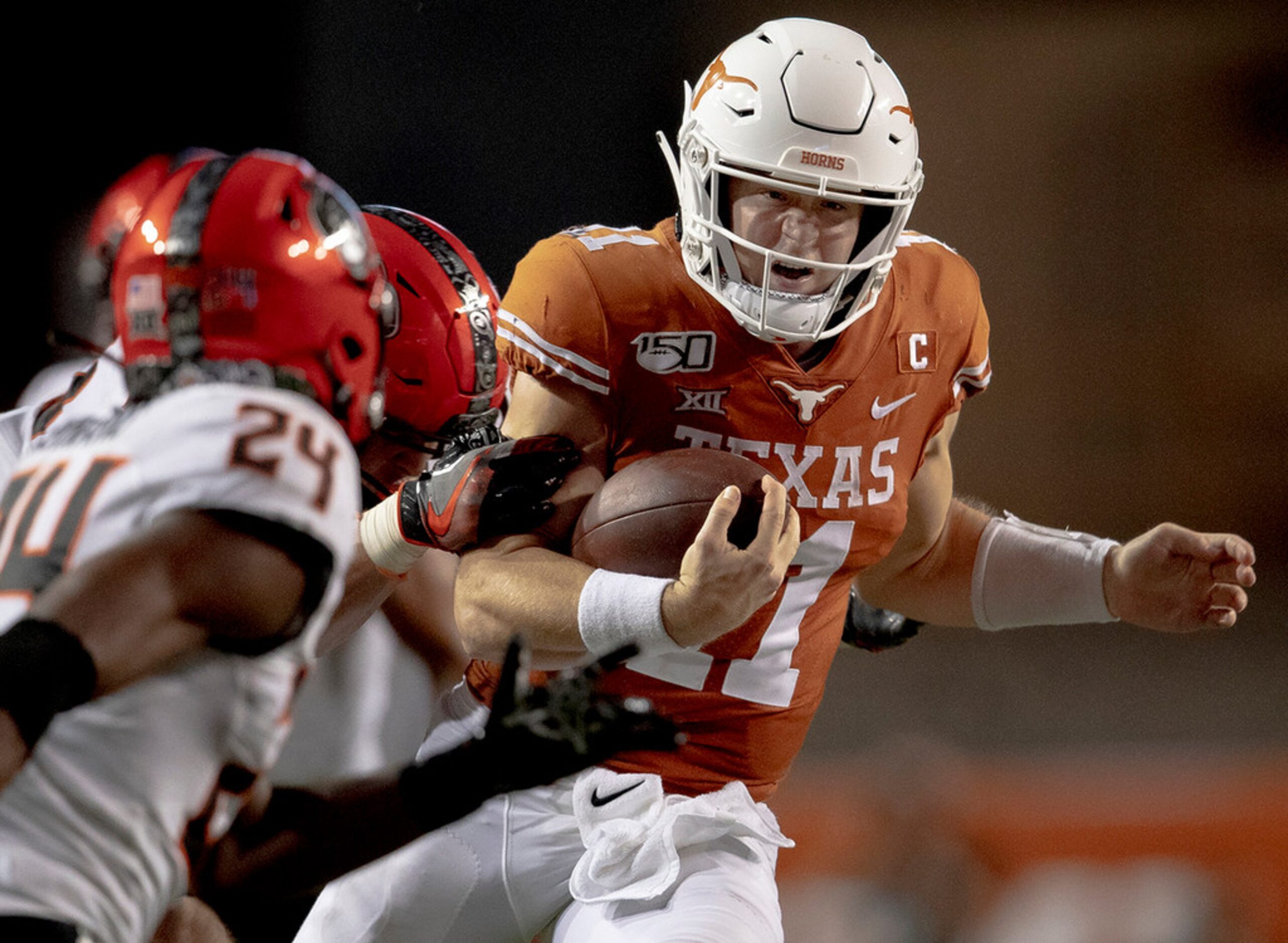 Texas quarterback Sam Ehlinger (11) runs the ball against Oklahoma State on Saturday, Sept....