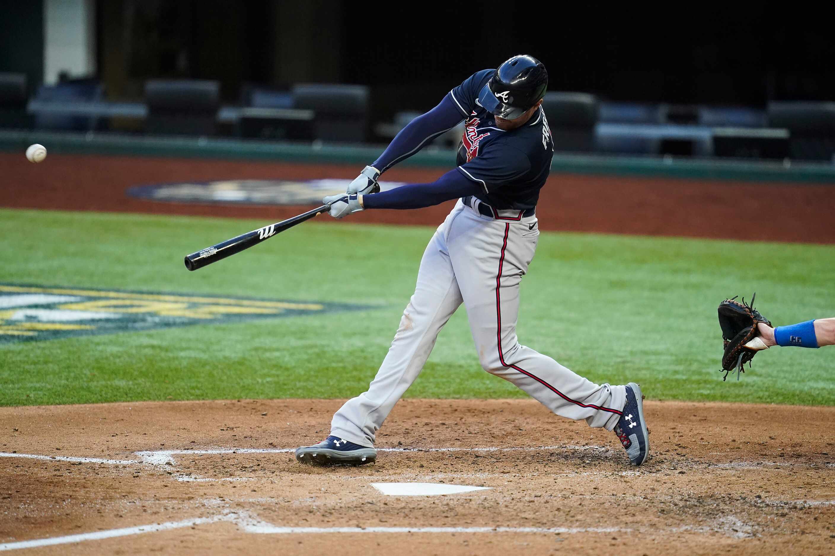 Atlanta Braves first baseman Freddie Freeman hits a 2-run home run during the fourth inning...