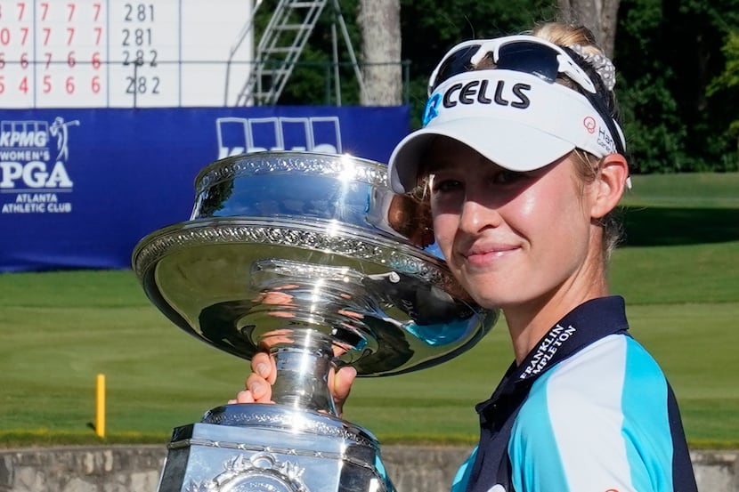 Nelly Korda of the U.S. holds the trophy after winning the KPMG Women's PGA Championship...