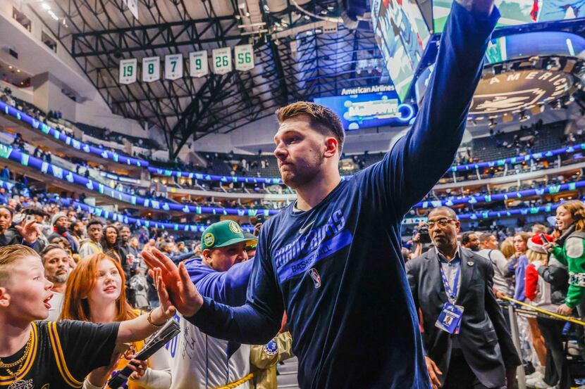 Dallas Mavericks guard Luka Doncic (77) celebrates with fans a win over Los Angeles Lakers...
