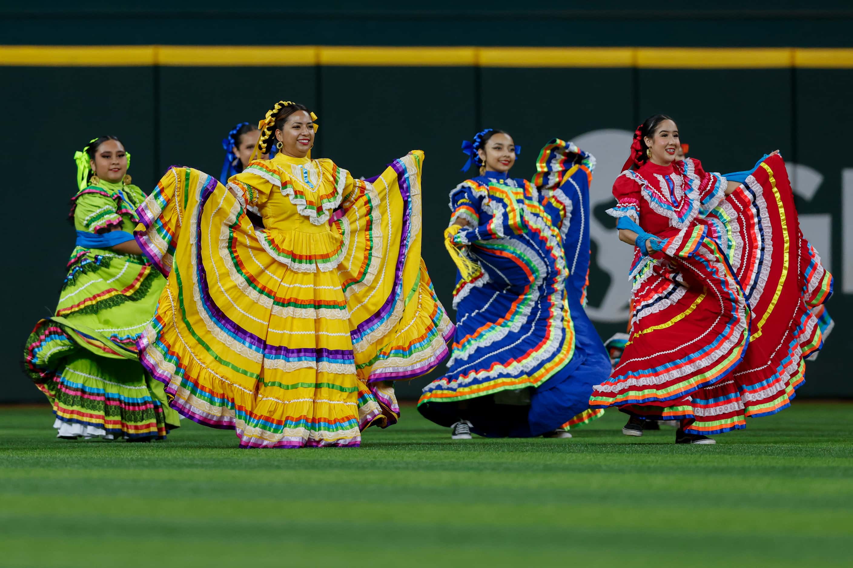 Folklórico dancers perform in the outfield as part of the Texas Rangers celebration of...