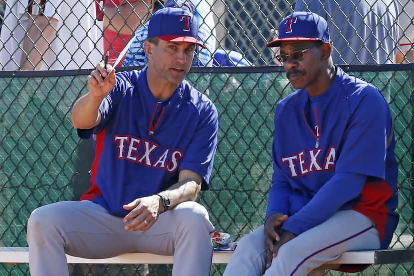 Bench coach Tim Bogar, left, talks with manager Ron Washington during an intrasquad game at...