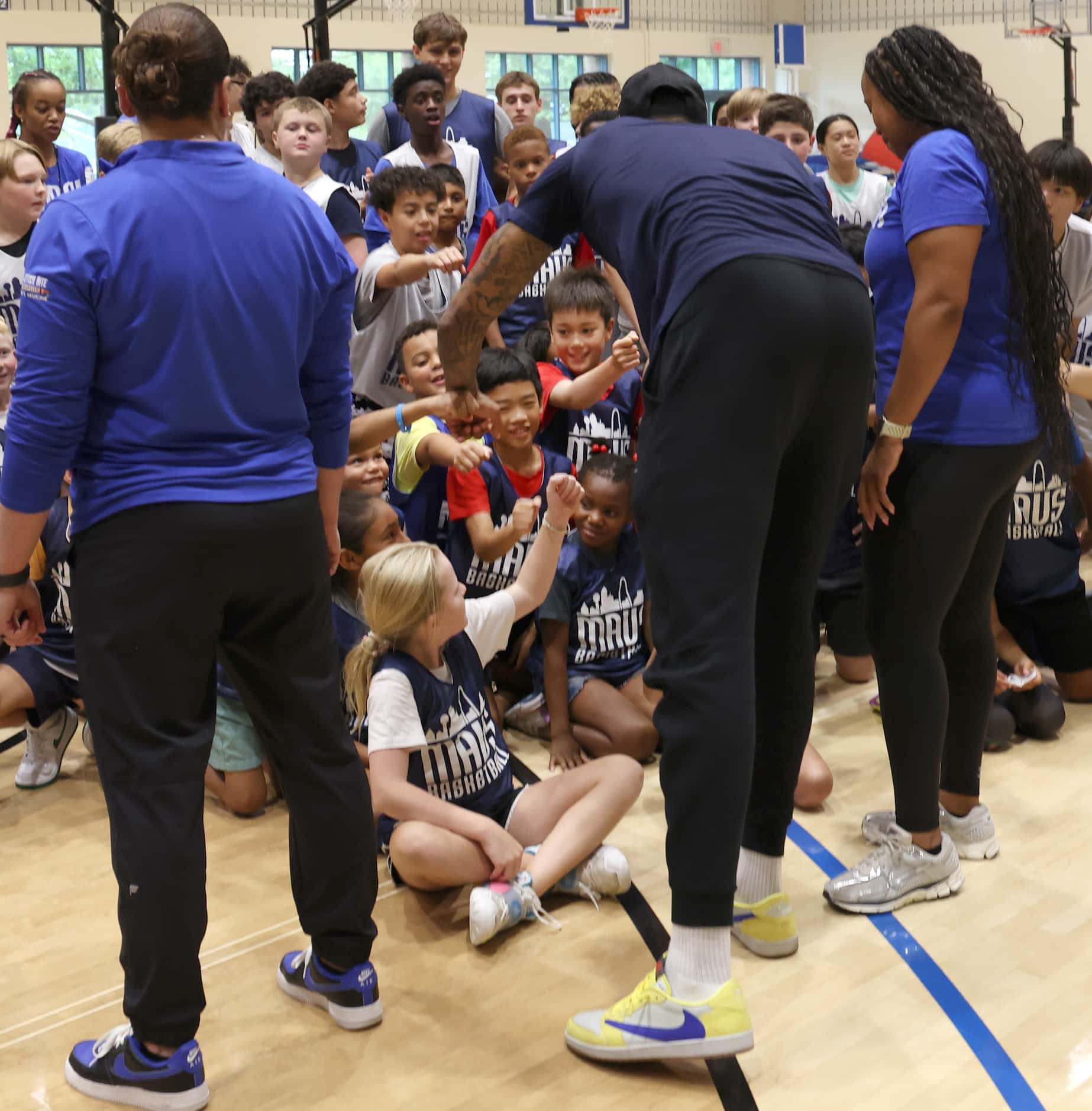 Dallas Mavericks forward and center PJ Washington, center foreground, squeezes in time for...