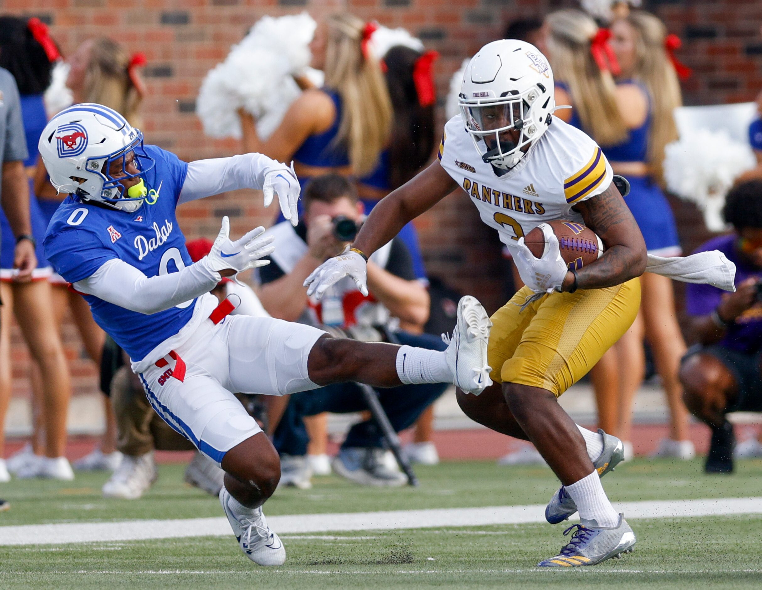 Prairie View A&M long snapper Benjamin Stewart (30) sheds a tackle attempt from SMU safety...