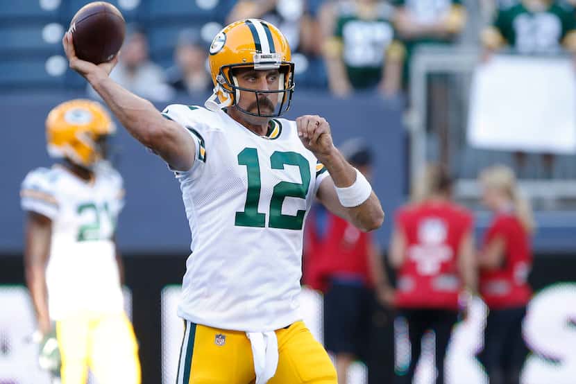 Green Bay Packers quarterback Aaron Rodgers warms up for the team's NFL preseason football...