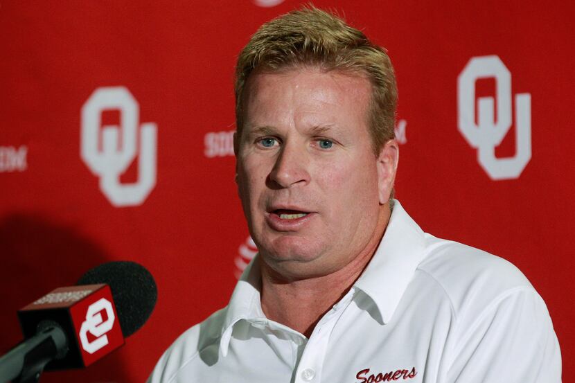 Mike Stoops, Oklahoma associate head coach and defensive coordinator, answers a question...