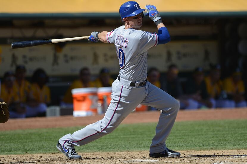 Michael Young of the Texas Rangers hits an RBI double driving in Josh Hamilton in the third...