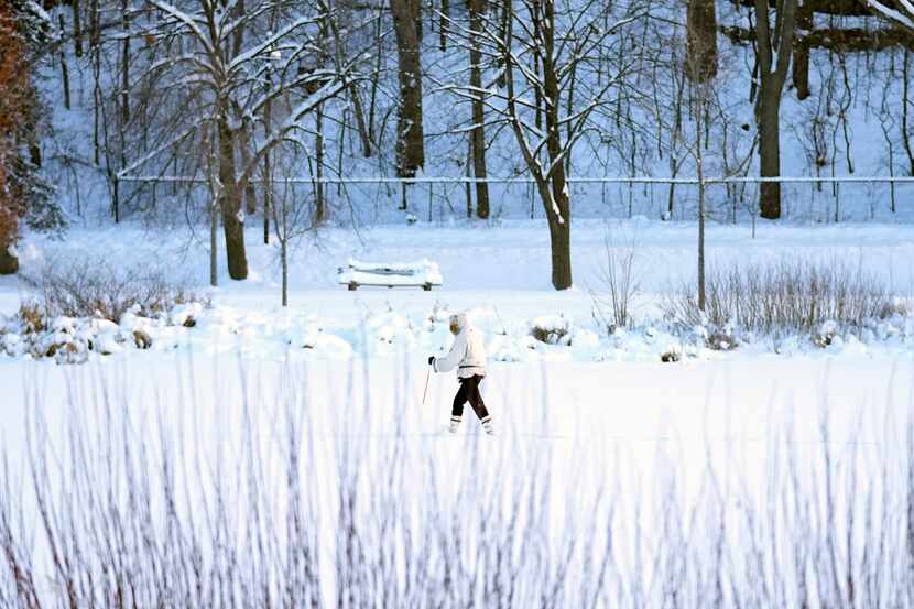 A skier makes her way across Lake of the Isles Thursday, Dec. 22, 2022, in Minneapolis. (AP...