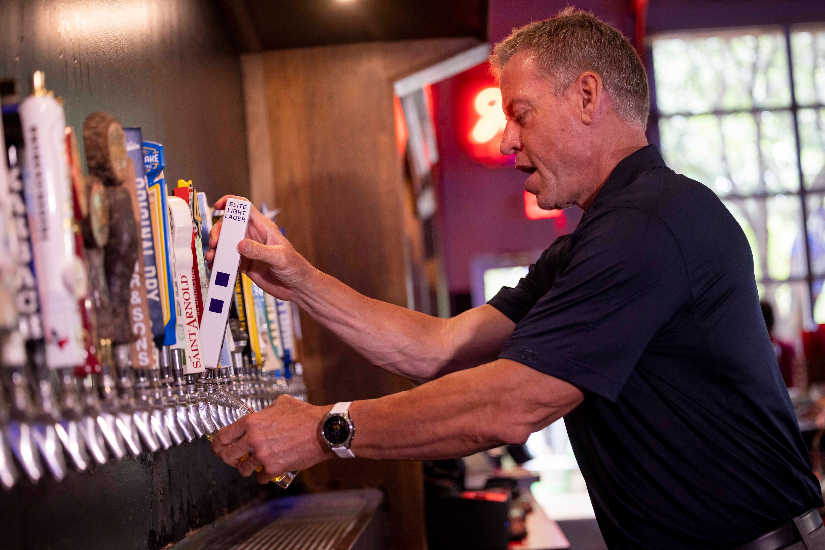 Former Cowboys quarterback Troy Aikman pours his beer EIGHT from the tap at Katy Trail Ice...