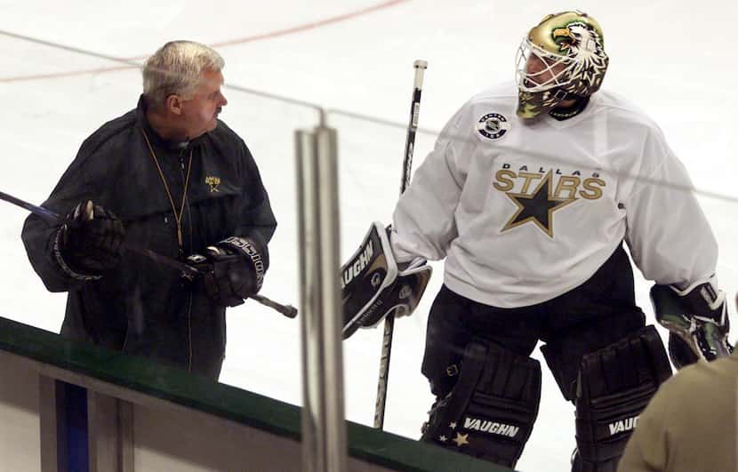 FILE — Dallas Stars' coach Ken Hitchcock exchanges greetings with goalie Ed Belfour as the...