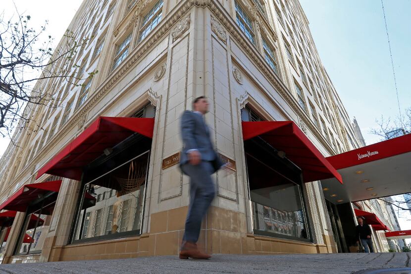 A pedestrian walks by the Neiman Marcus department store at Main and Ervay streets in...