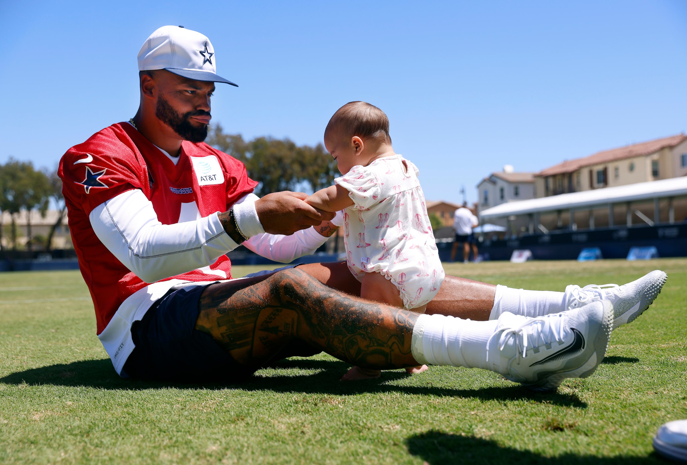 Dallas Cowboys quarterback Dak Prescott plays with his baby daughter Margaret Jane Rose...