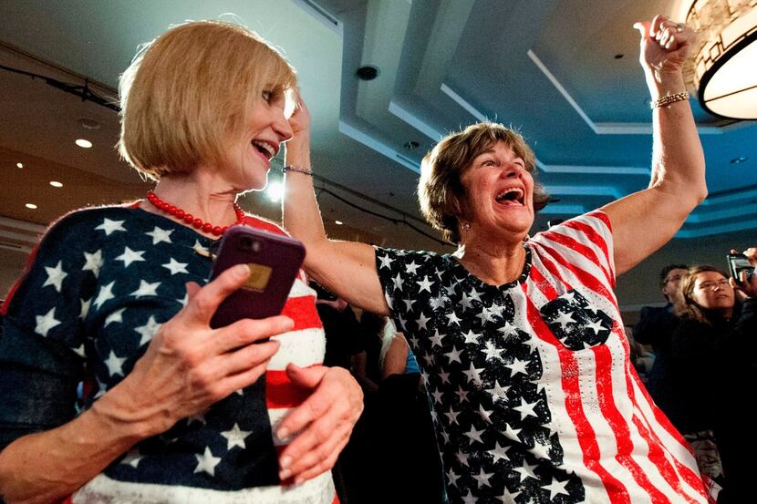 Karen Magnuson (left) and Karen Shaw celebrate after the announcement of the victory of...