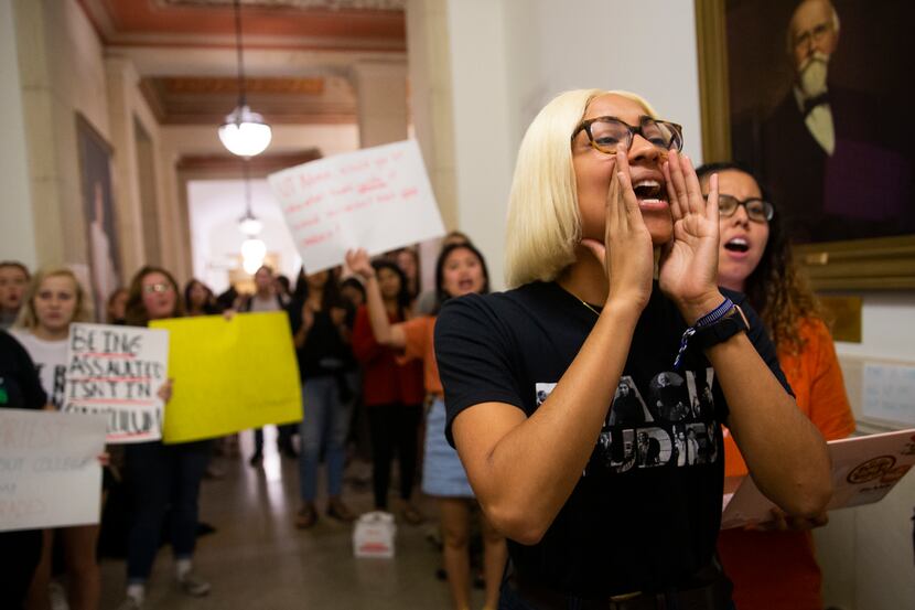 UT Austin junior Simone Gabriela Harry leads a chant outside of Executive Vice President and...