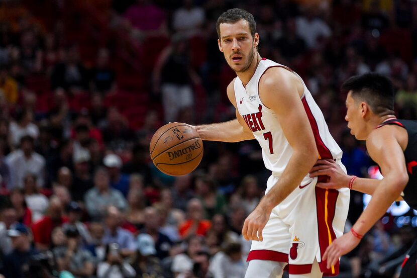 Miami Heat guard Goran Dragic (7) looks for an open teammate while Toronto Raptors guard...