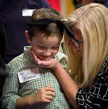 Cindy Krueger embraces her grandson, Harley Archibald, after the Children's Medical Center...