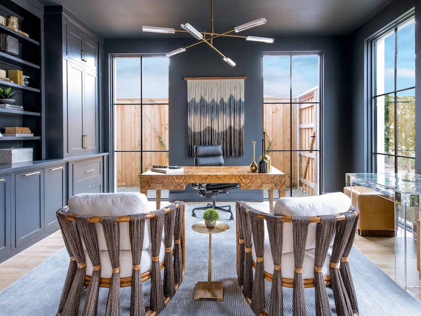 An office with a brass chandelier and blue walls, trim and ceiling.