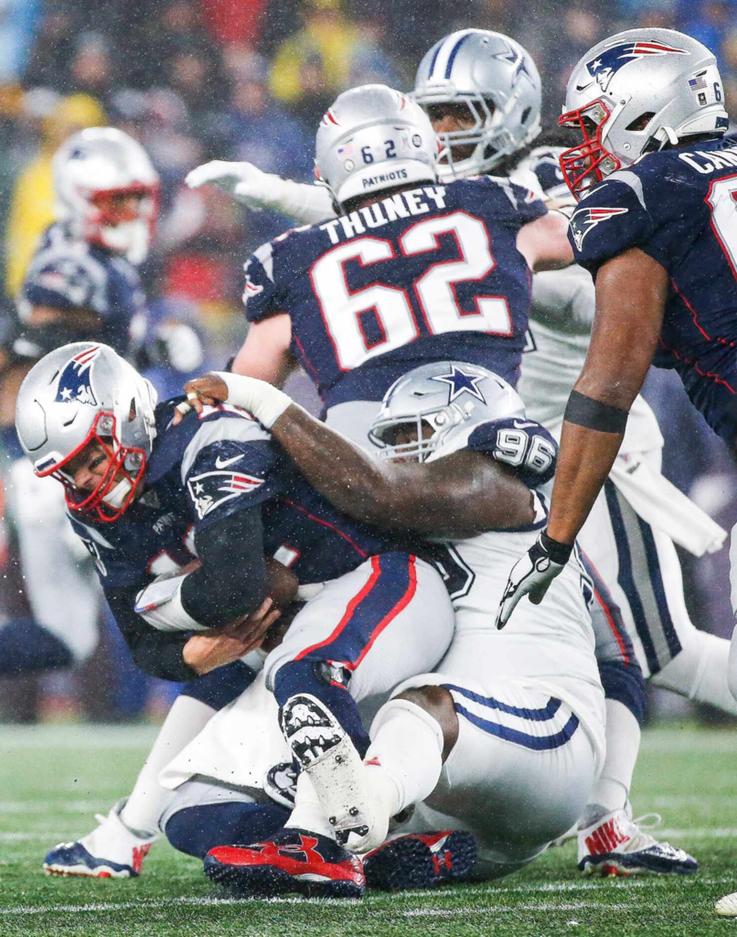 New England Patriots quarterback Tom Brady (12) is sacked by Dallas Cowboys defensive tackle...
