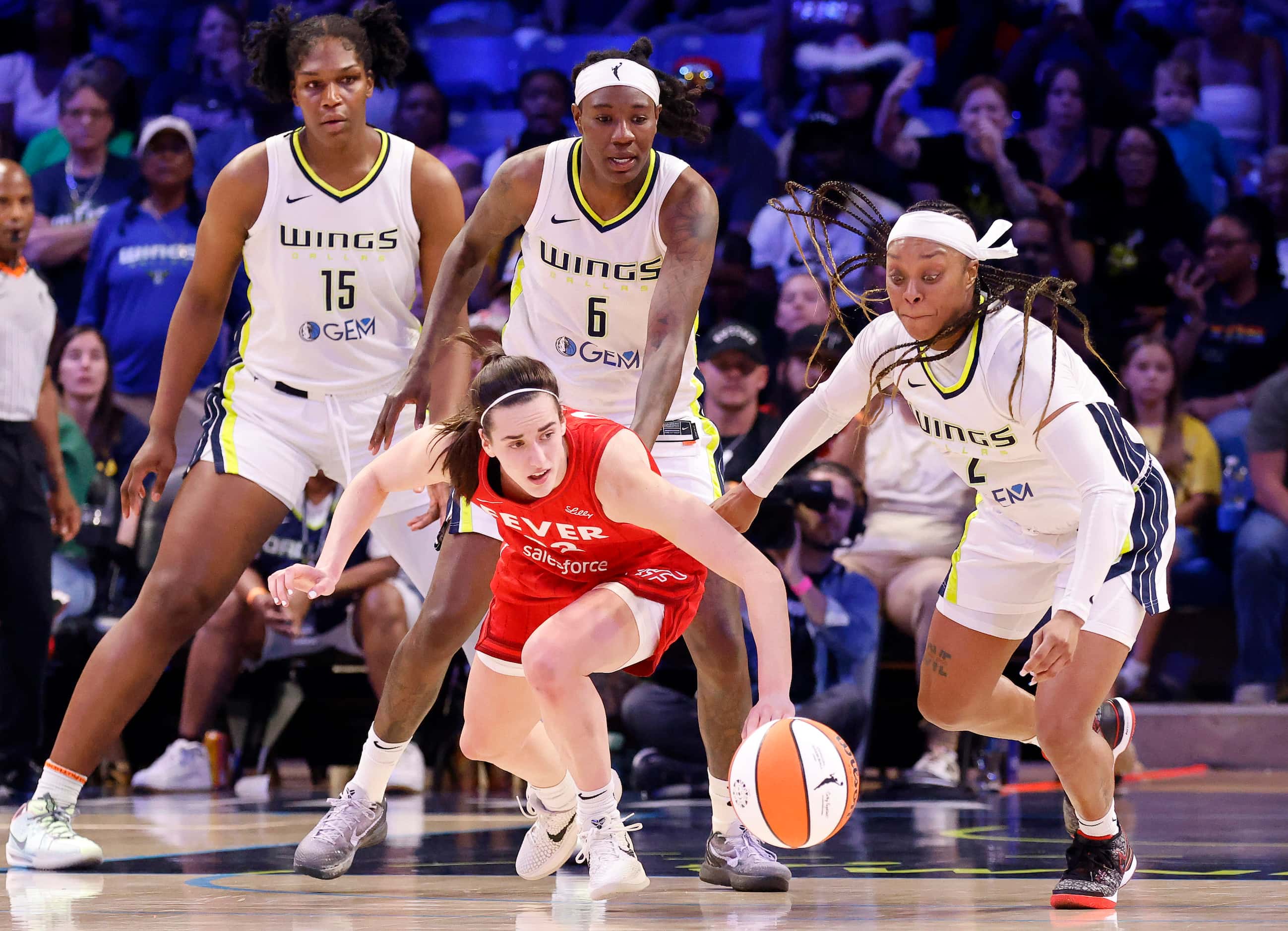 Indiana Fever guard Caitlin Clark (22) turns and reaches for the ball after Dallas Wings...
