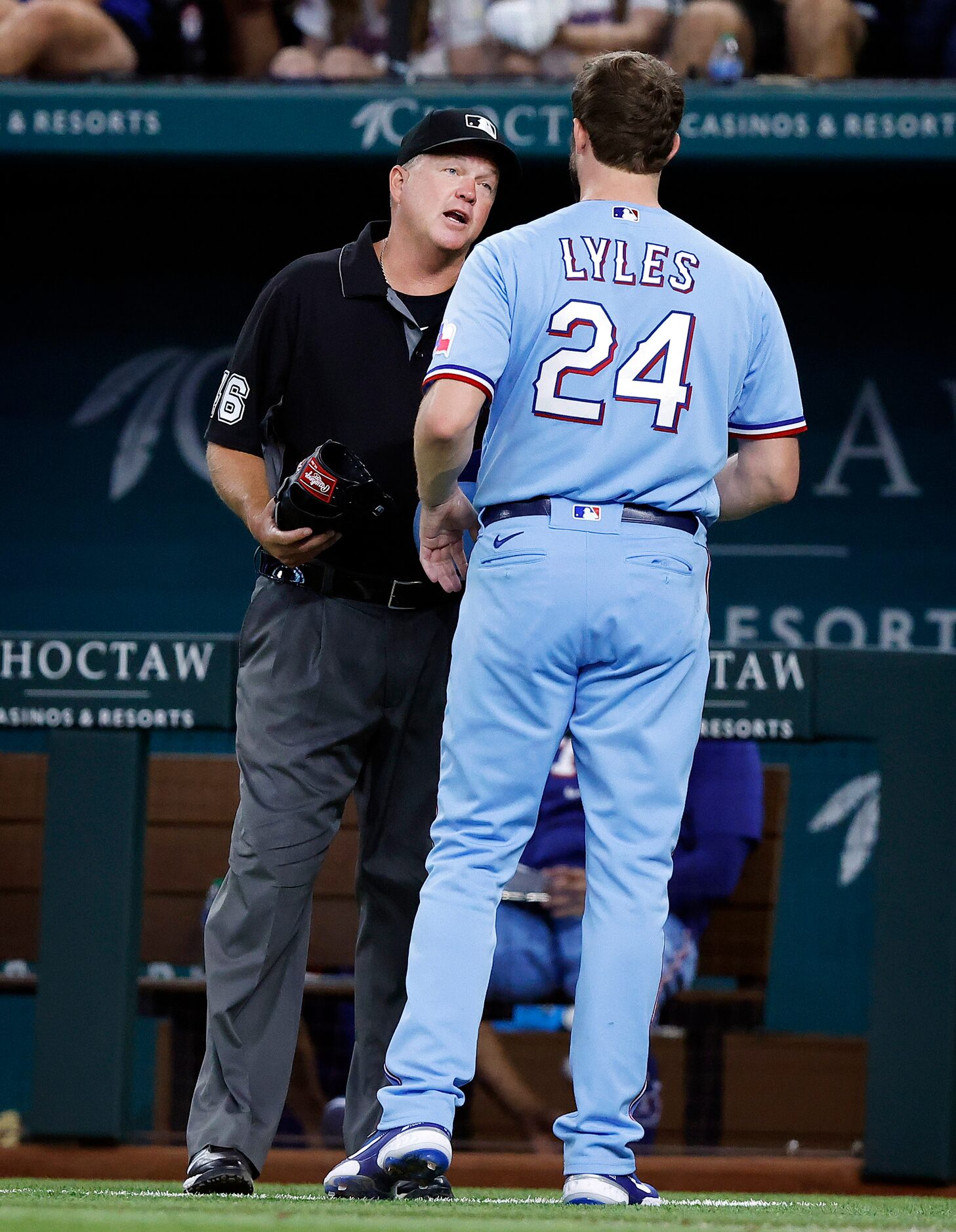 Texas Rangers starting pitcher Jordan Lyles (24) has his glove checked by first base umpire...