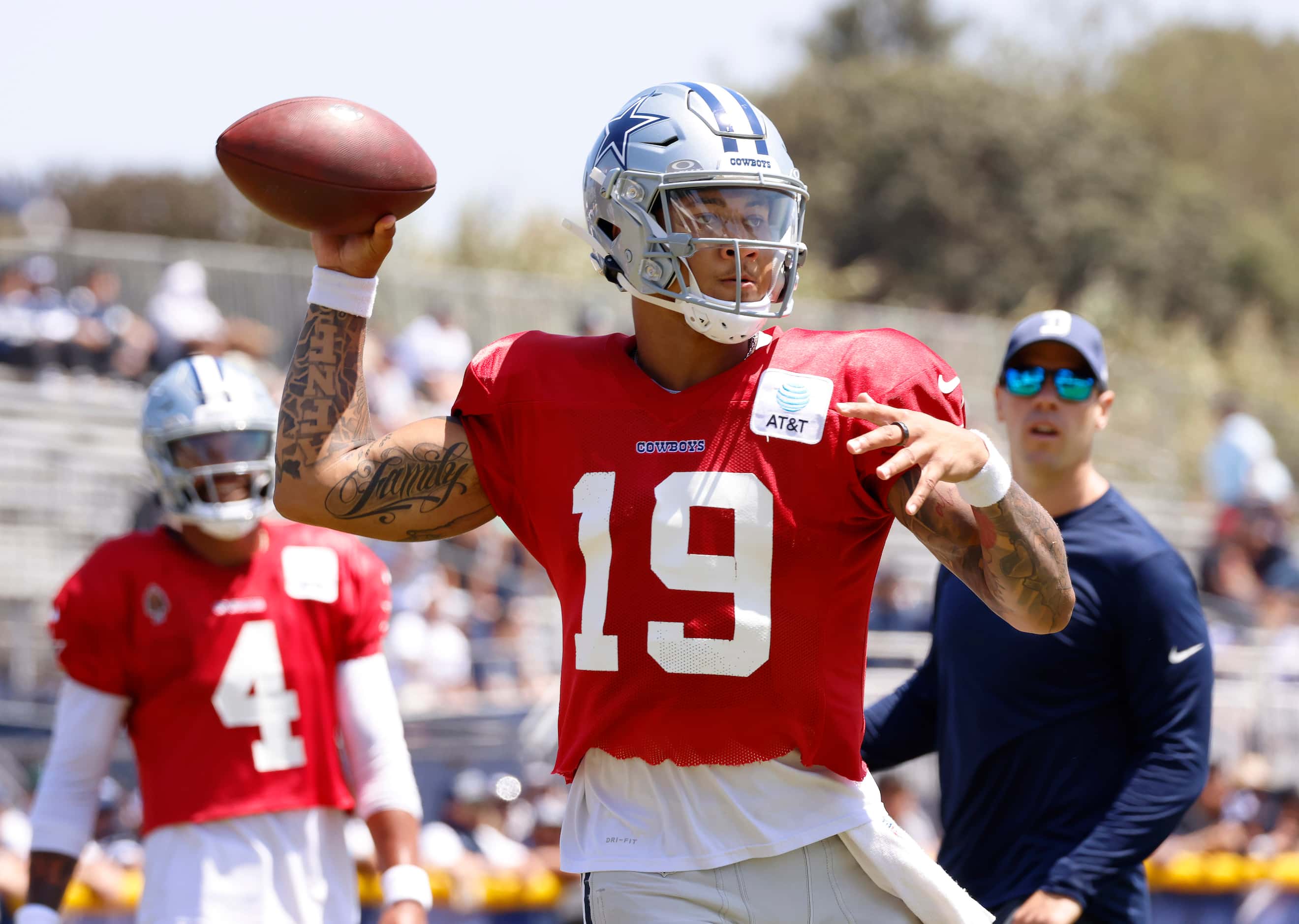 Dallas Cowboys quarterback Trey Lance (19) throws to target as he rolls out during training...