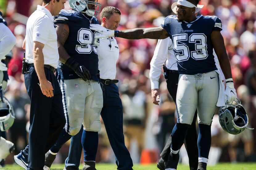 Dallas Cowboys defensive tackle Antwaun Woods (99) gets a pat on the chest from linebacker...