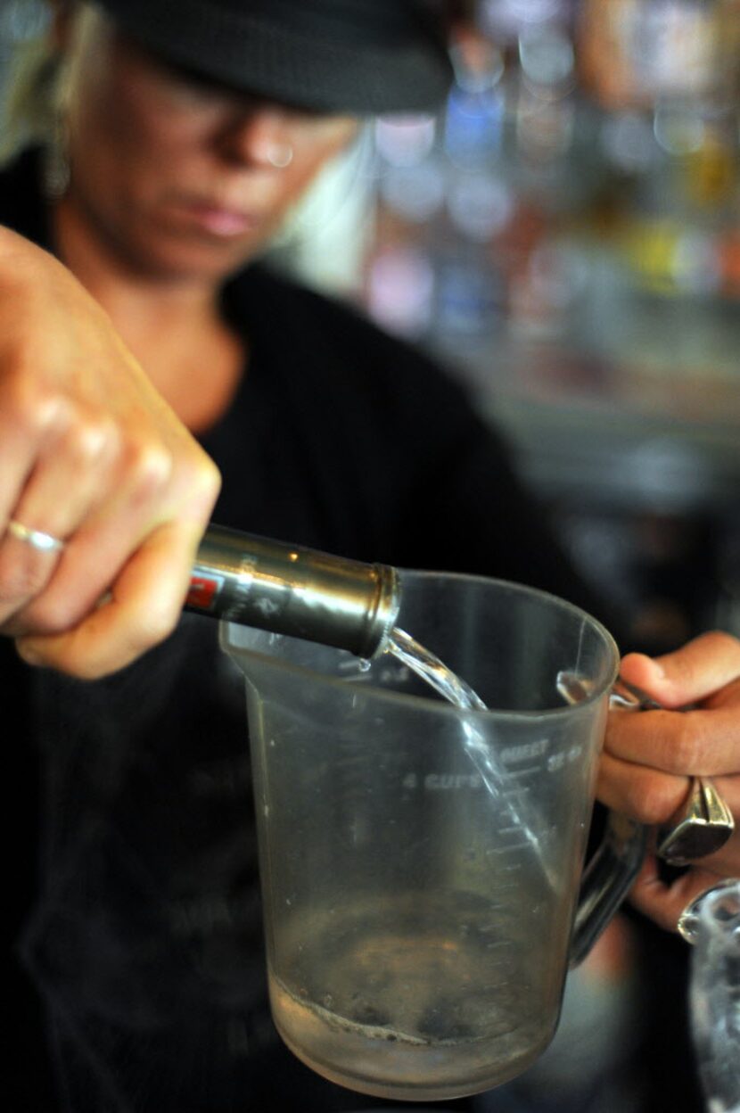 Vodka is measured for brunch punch.