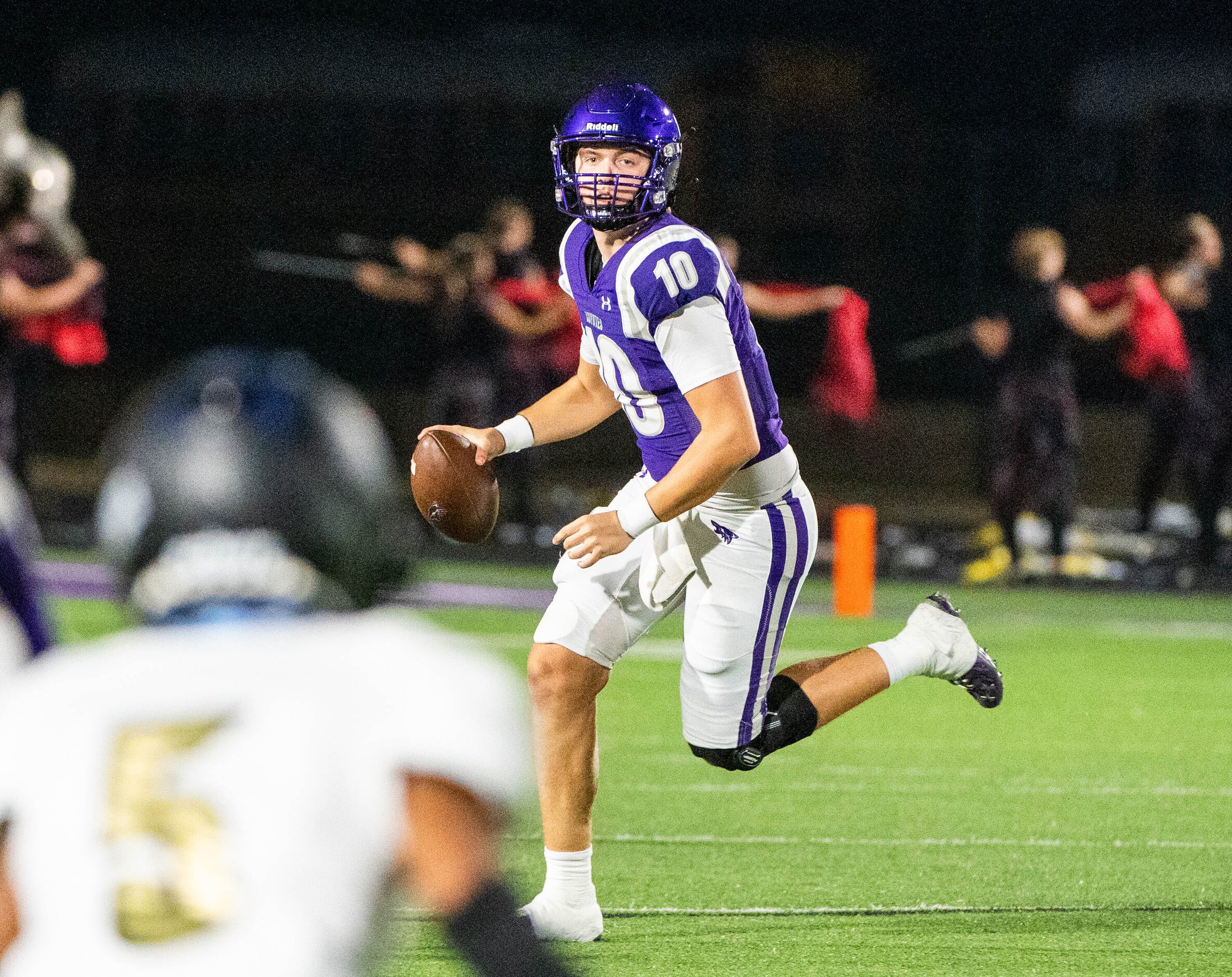 Anna quarterback Evan Bullock (10) looks to pass in the first half during a high school...