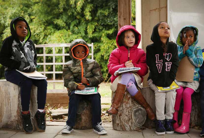 First grade students lesson to instruction before planting seeds in the John J. Pershing...