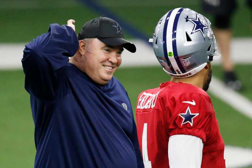 Dallas Cowboys head coach Mike McCarthy smiles as he talks with Dallas Cowboys quarterback...