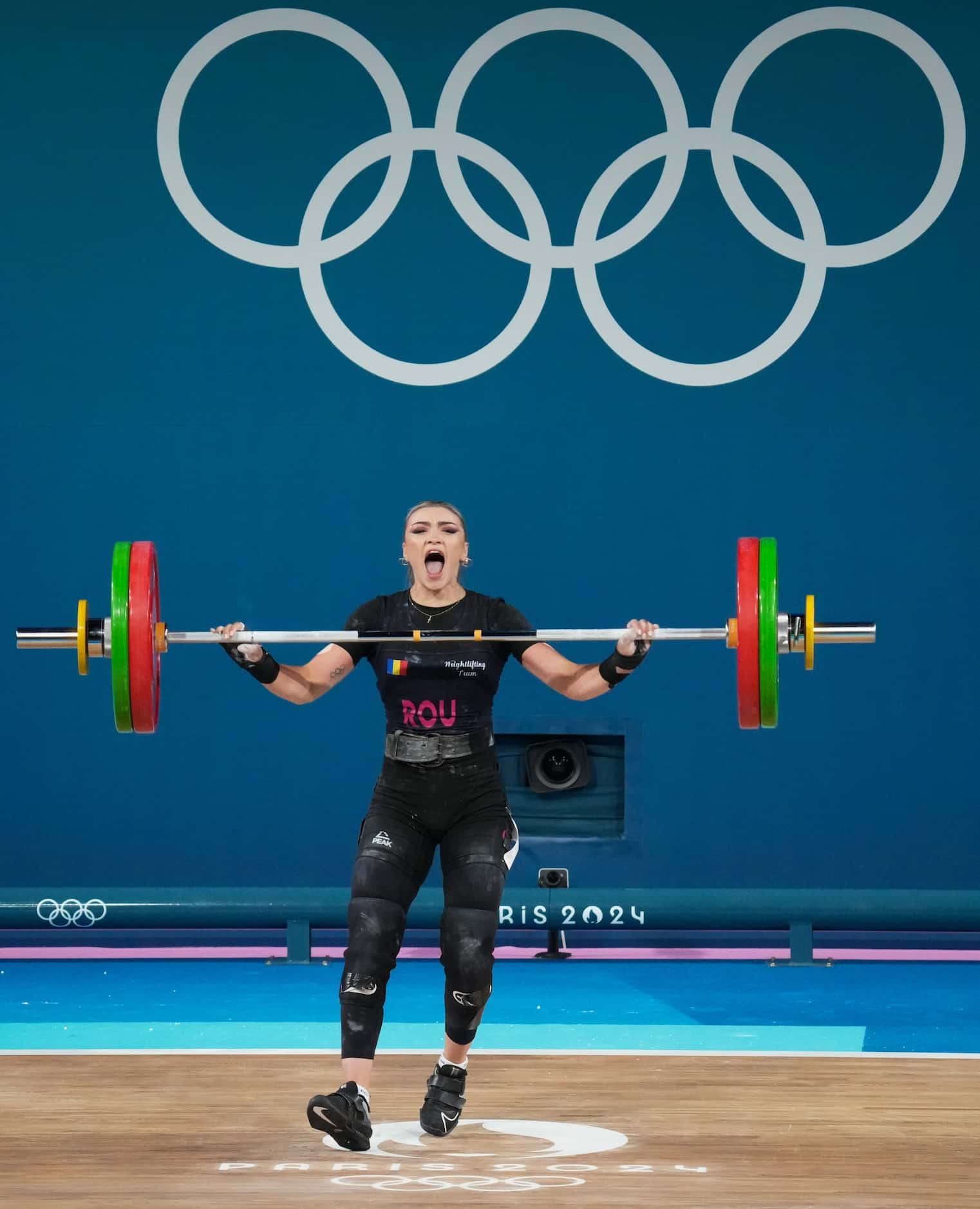 Mihaela Cambei of Romania reacts after lifting 93kg in snatch segment during women’s 49kg...