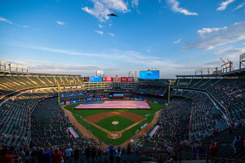 A B-2 Spirit based at Whiteman Air Force Base performs a flyover of Globe Life Park before a...
