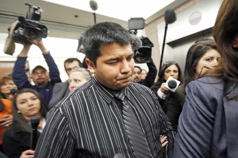 Erick Muñoz 's attorneys escorted him through a throng of journalists after Friday's court...