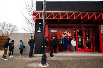 Fried chicken fans brave the cold temperatures as they wait outside of Hattie B's on its...