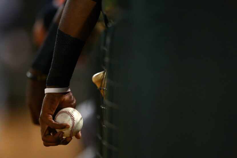 Nov 2, 2013; Surprise, AZ, USA; Detailed view of a player holding a baseball in the dugout...
