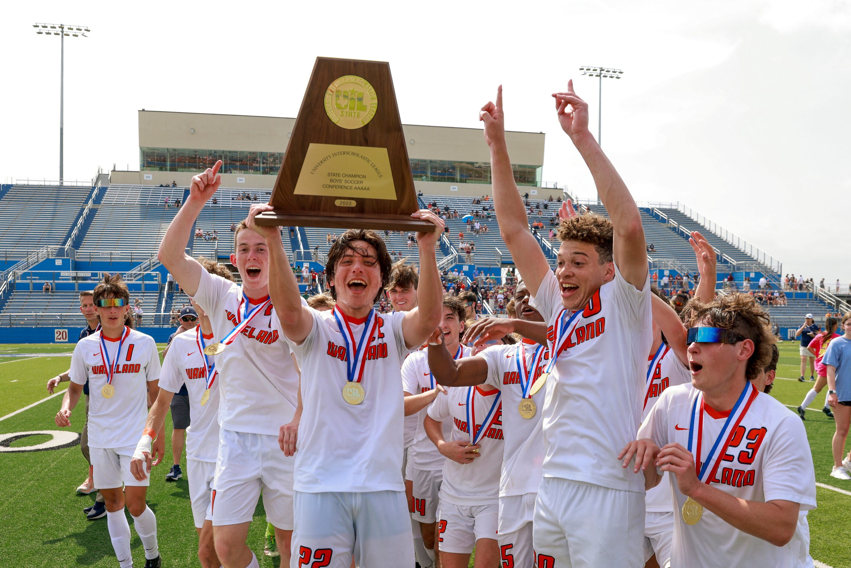 Frisco Wakeland forward Brennan Bezdek (22) raises  the Class 5A boys soccer state...