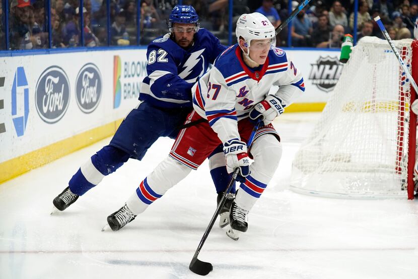 New York Rangers defenseman Nils Lundkvist (27) carries the puck in front of Tampa Bay...
