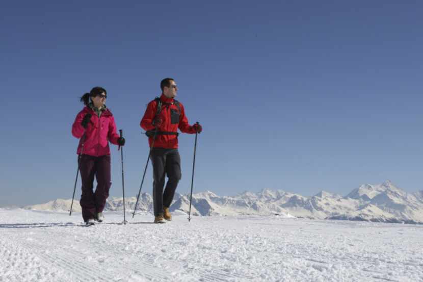 Hikers enjoy some of the well-groomed winter trails in Crans-Montana, Switzerland.